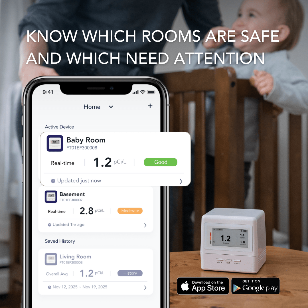 Home radon monitor with app on smartphone displaying radon measurements, with a child in the background.
